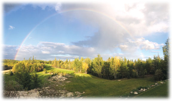 photo of rainbow over golf course